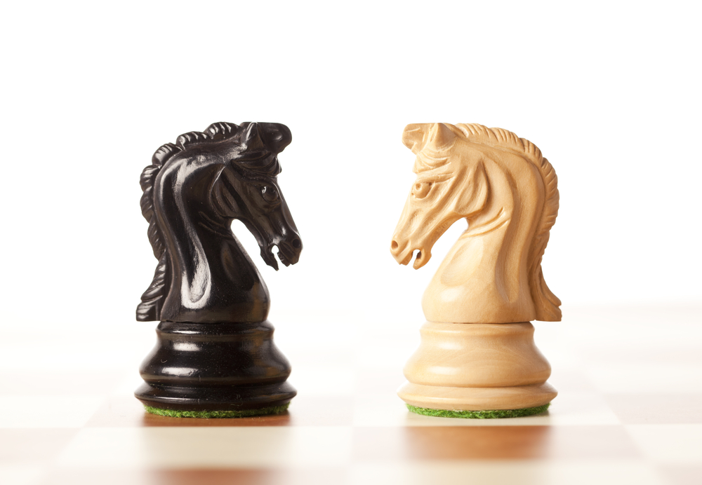 Difficult conversations: black and white chess pieces facing off