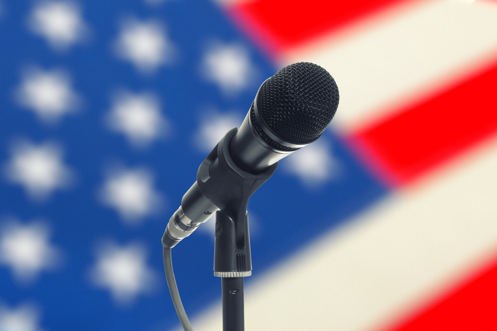 Microphone against a backdrop of the US flag